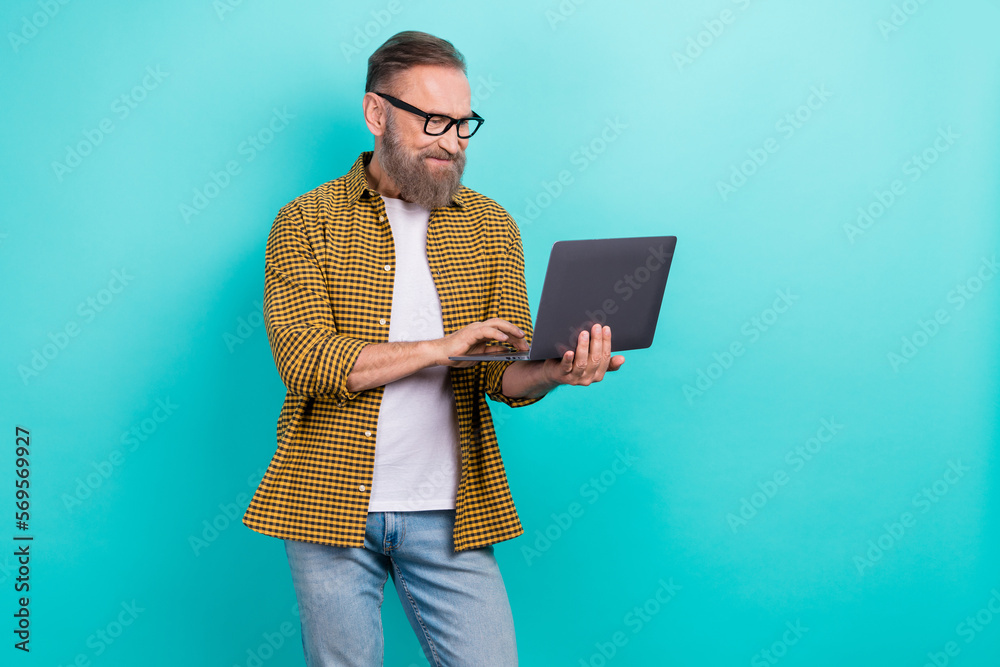 Wall mural photo of professional experienced programmer coder man hold his netbook wear eyeglasses concentrated