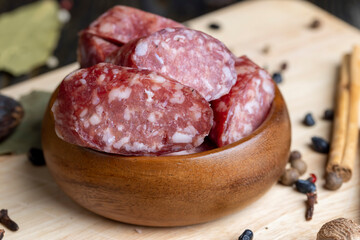 Dried veal sausage during slicing