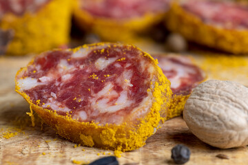 Sliced pork salami with spices and lots of turmeric
