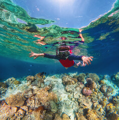  Beautiful maldives tropical island - a boy snorkels underwater.