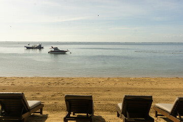 Line up of lounge chairs facing the beach