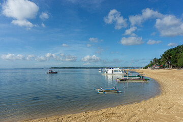 Fototapeta na wymiar Sanur, Bali (2 February 2023) : Fishing boats are moored on the beach