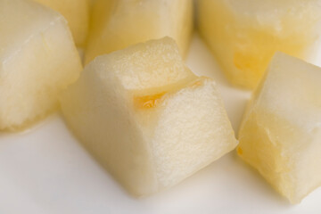Ripe yellow melon cut into pieces and portions