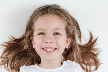 Happy smiling child portrait on the white background. Little todler attractive lovely curious...