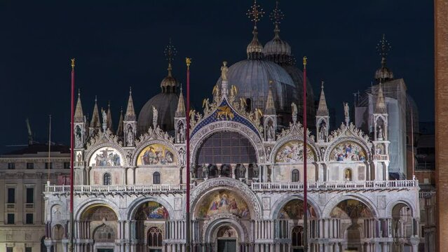 Basilica of St Mark night timelapse. It is cathedral church of Roman Catholic Archdiocese of Venice. It located at Piazza San Marco. Tourists walking in front of it. Venice, Italy