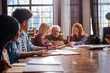 Fototapeta premium Professor mentoring young students in class.