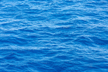 Obraz premium Very nice sea water background or backdrop with selective focus. Small waves of natural water surface texture.