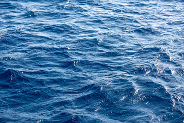 Very nice sea water background or backdrop with selective focus. Small waves of natural water surface texture.