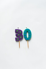 top view of number candles, number 30 candle on a white background, birthday candles on white background