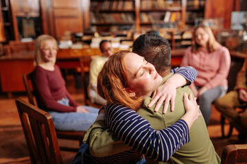 Patients hugging in counseling session.