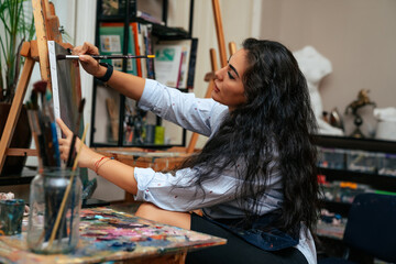 young artist working on a painting at the studio