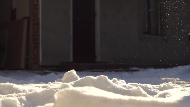 a boy kicks a ball in the snow slow motion