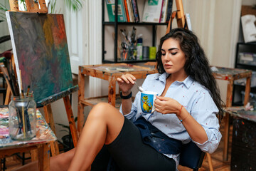 young artist working on a painting at the studio