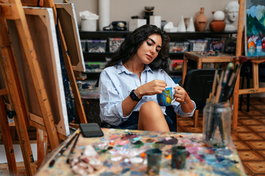 young artist working on a painting at the studio