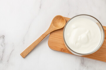 Creamy natural yogurt on a light background, Probiotic cold fermented dairy drink. Long banner format. top view