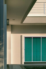 Fototapeta premium Sunlight and shadow on exterior wall surface of modern house in vertical frame, architecture background concept