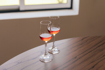 Two glasses of sweet moscatel wine on a wooden table 