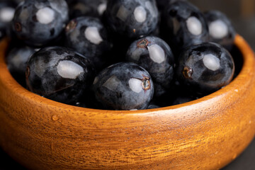 sweet ripe black grapes covered with drops of water
