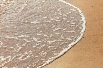 Sandy shore with sea water.