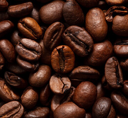 Grains of black coffee as a background.