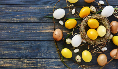 yellow colored Easter eggs and regular egg on wooden holiday banner, background, selective focus...