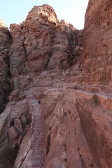 Fototapeta na wymiar Stairs on the al Khubtha trail leading up to a view point onto the Treasury, Petra, Jordan