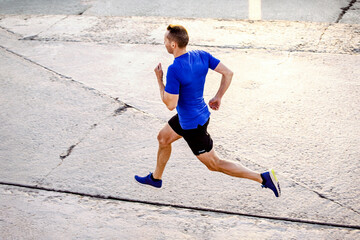 middle-aged male runner run on road