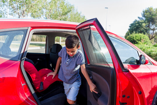 Boy Getting Out Of A Car For School