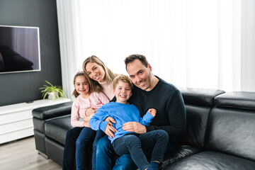 Family of four having fun on new modern house