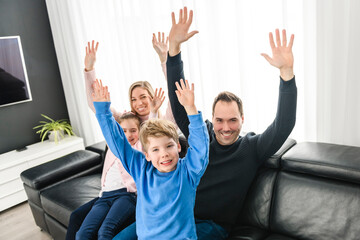 Obraz premium Family of four having fun on new modern house
