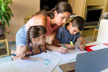 Mother with children doing homework at home