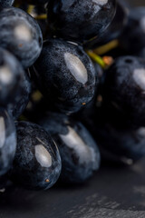 sweet ripe black grapes covered with drops of water