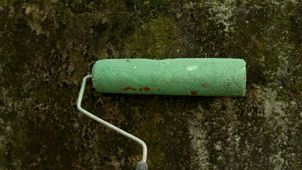 close-up photo of green wall paint roll