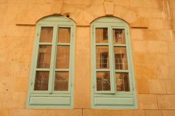 Fototapeta na wymiar Turquoise, baby blue windows in As-Salt, Salt, Jordan