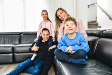 Obraz premium Family of four having fun on new modern house