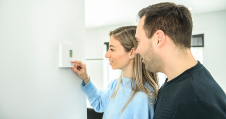 couple set the thermostat at home house