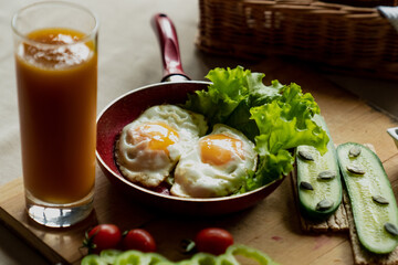 nice breakfast, scrambled eggs and a glass of fresh juice