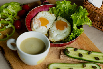 classic breakfast, scrambled eggs, simit bun, fresh vegetables, cucumber