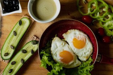 classic breakfast, scrambled eggs, simit bun, fresh vegetables, cucumber