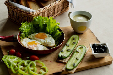 classic breakfast, scrambled eggs, simit bun, fresh vegetables, cucumber
