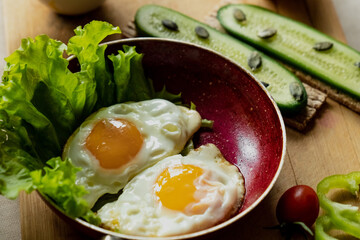 classic breakfast, scrambled eggs, simit bun, fresh vegetables, cucumber