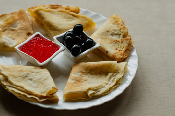 Pancake with red caviar and olives for breakfast, mint coffee