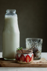 Healthy food, bottle of milk, tiramisu and frozen coffee