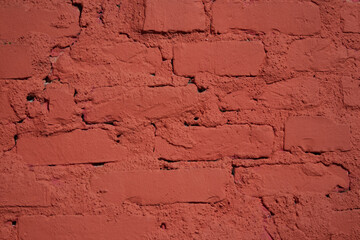 Textured red color brick wall background closeup
