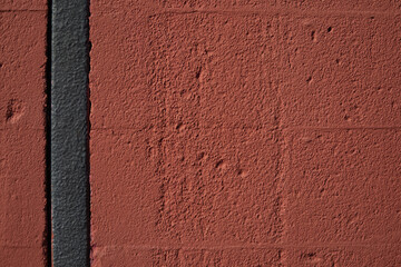 Textured red color brick wall background closeup