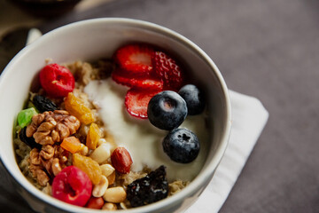 oatmeal with berries and nuts, yogurt, close-up