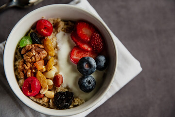oatmeal with berries and nuts, yogurt, close-up