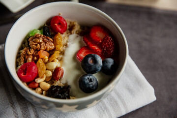 oatmeal with berries and nuts, yogurt, close-up