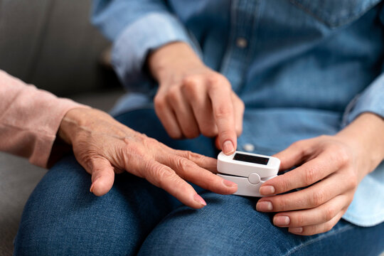 Nurse Helping To Senior Woman Using Blood Sugar Test On Finger In Living Room. Health, Innovation And Daily Life Of Diabetic Lady With Glucometer To Check Glucose Level In Her Home