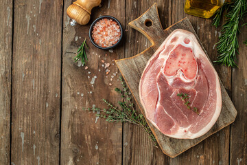 Raw ham cut, pork leg on a wooden background, banner, menu, recipe place for text, top view